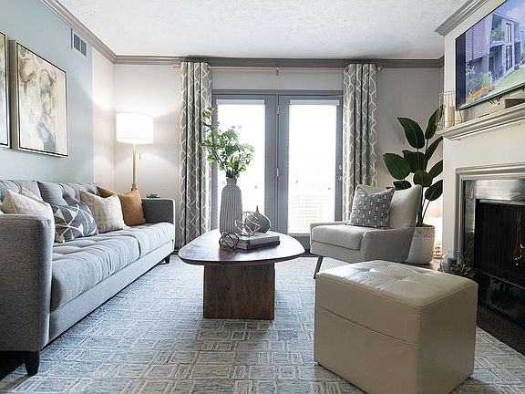Spacious living room with hardwood-style flooring & fireplace
