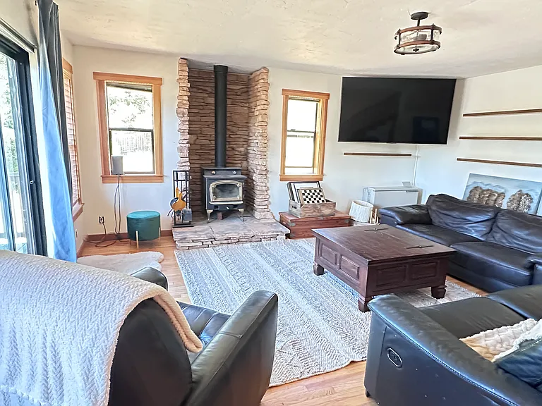 Living room with wall heat and wood stove