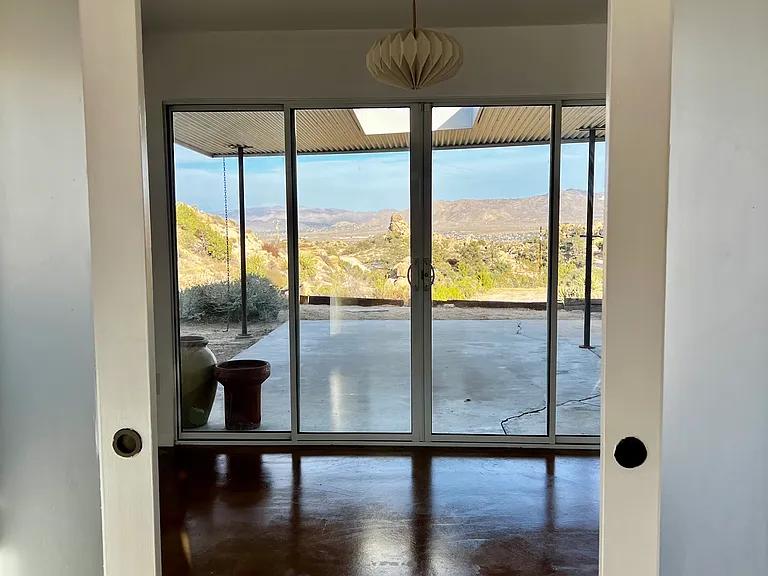 view looking out the bedroom into dining area