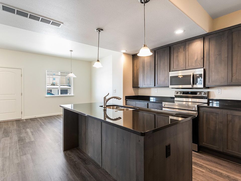 Beautiful Kitchen with Granite, SS Appliances, Soft Close Cabinets & Drawers. Dining area in background.