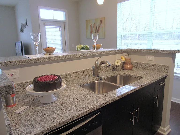 Double sink, stainless steel dishwasher, and space to spread out_your kitchen's ready for anything.