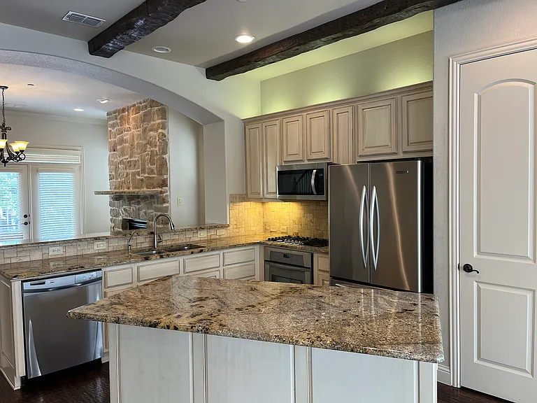 Beautiful kitchen with designer cabinets, high-end appliances, and refrigerator