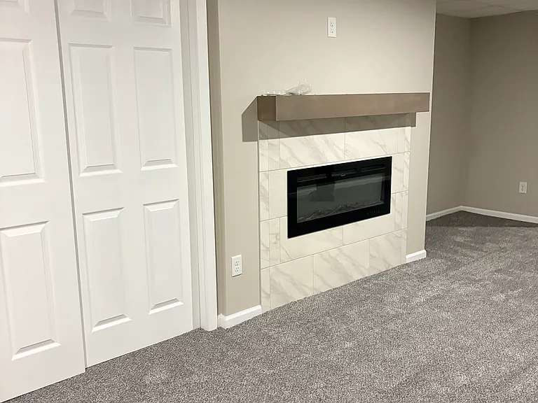 Electric fireplace and closet in the living room.