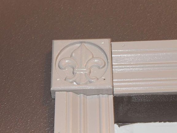Decorative moldings around triple glass window in living room