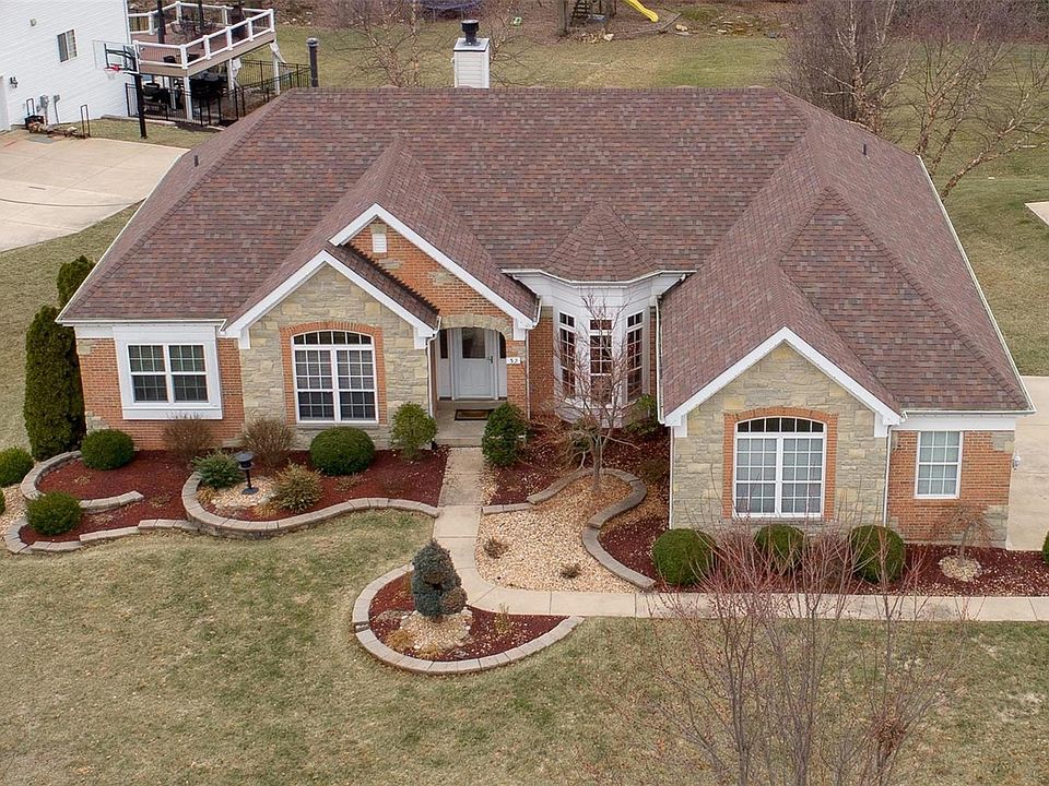 Inviting brick and stone exterior welcomes you to 32 Grasemere Ct.