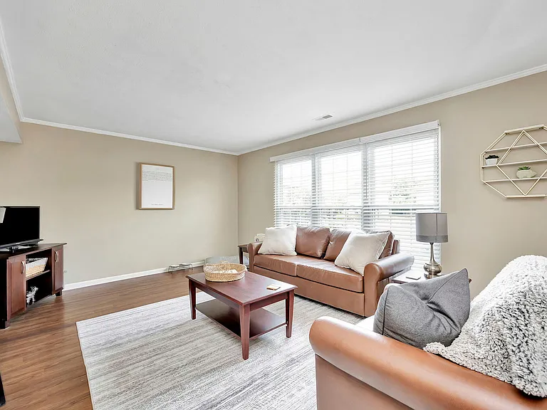 Elegant Wood-Style Flooring in Living Room at The Commons Student Apartments in Oxford, OH