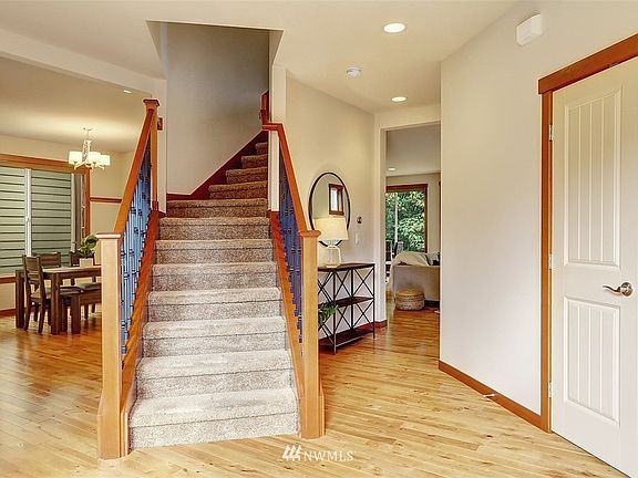 Birds eye maple hardwoods grace the entire main floor; the foyer features beadboard wainscoting and curved iron stairway leading to the upper level.