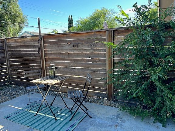 Enjoy the private fenced back yard with concrete patio and contemporary horizontal fence.