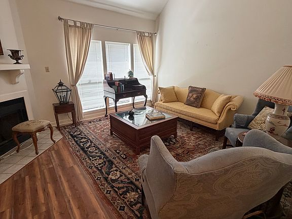 Living room with vaulted ceilings, fireplace. Beautifully furnished