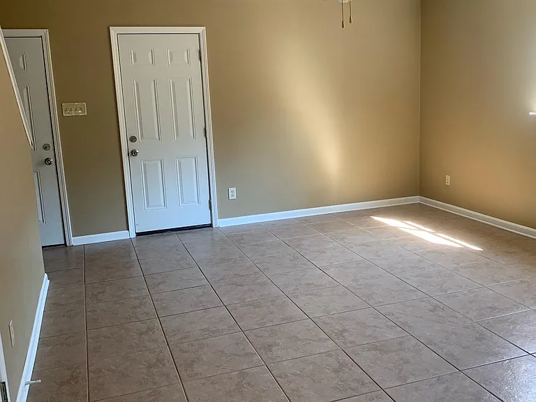 living room and entrance door on the left and the door on the right is to the garage