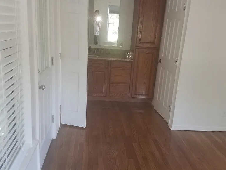 Bedroom to Bathroom. Door goes to small balcony with washer dryer in closet.