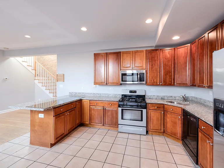 HUGE Kitchen with stainless steel appliances and granite counter tops.