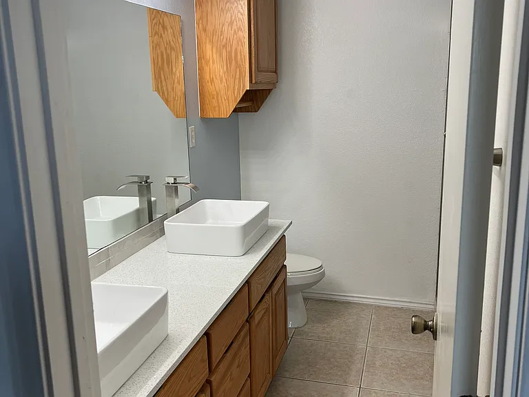 Primary private bathroom with double vanity sinks and quarts counter tops.