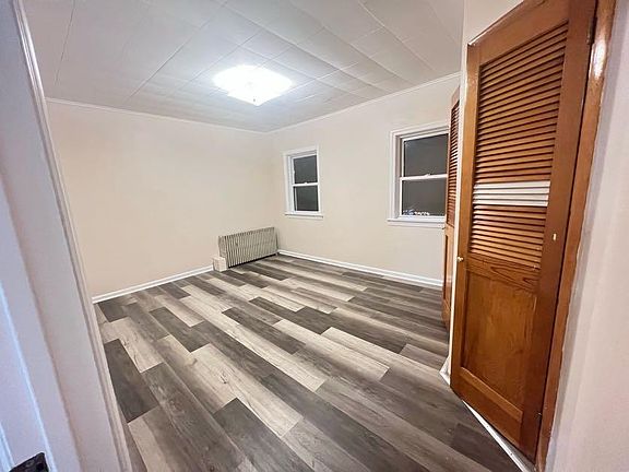 (Master Bedroom 1/3) Taken from the entrance. Closet offers shelving space for folded clothes or seasonal items such as heavy blankets or coats.