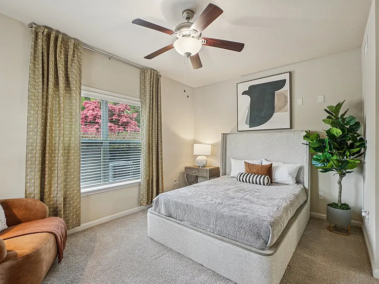 Bright and spacious apartment bedroom with contemporary finishes at Village at Broadstone Station in Apex, North Carolina