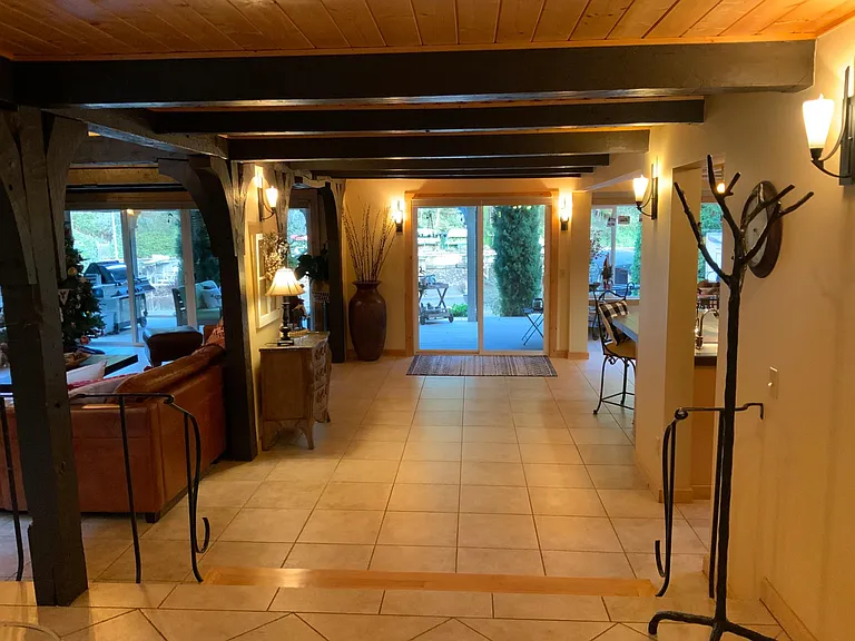 Continuing from entrance, step down into the living space. Main floor is radiantly heated by Travertine tiles making them comfortable to walk on without shoes. Windows to the waterfront.
