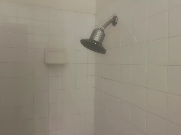 Big shower filter - for clean water - in the 2nd bathroom, which features a tub. Perfect for a baby.