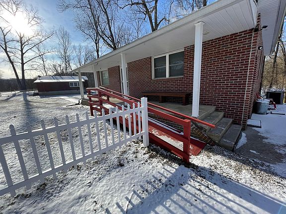 Front entry of the house with stairs and ramp. The building in the background is what we call the "barn" and is the additional building on the property
