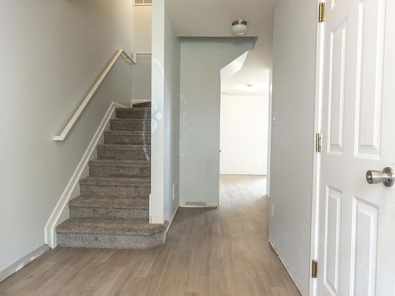 Entry way with door to the garage on the right, coat closet (not pictured) to the left