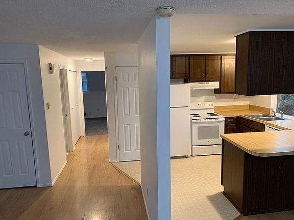 Spacious living room to the left, kitchen and hall to bedrooms ahead and dining room to the right.