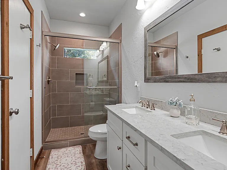Bathroom #1 - Walk-in shower with toilet and 2 sinks.