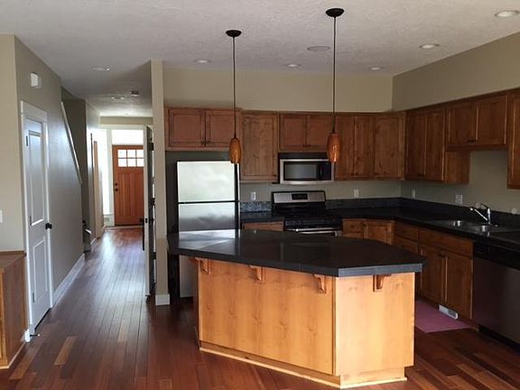 Main level has living room with gas fireplace, kitchen with 