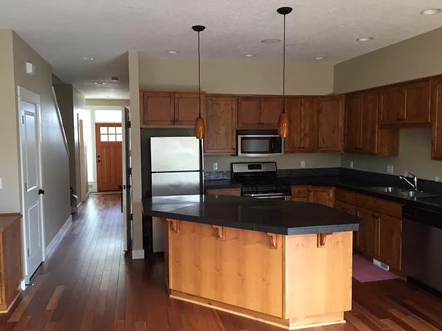 Main level has living room with gas fireplace, kitchen with center island