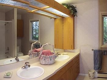 Second level full bathroom with double sinks.