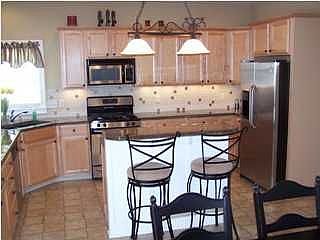 Large maple kitchen with unique polished countertop