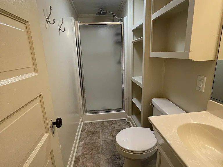 Space-saving full bath with plenty of storage for linens.
