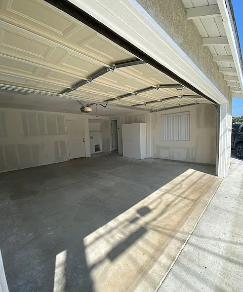 Garage with door to back patio and direct access to studio.