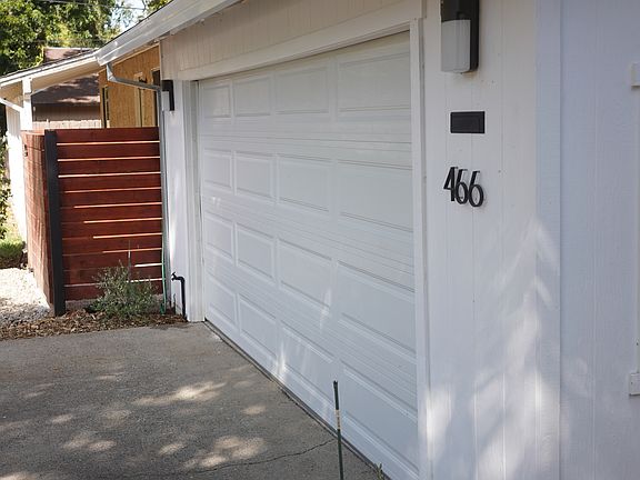 Garage with automatic garage door opener, storage room in garage as well as gated side yard for RV or boat
