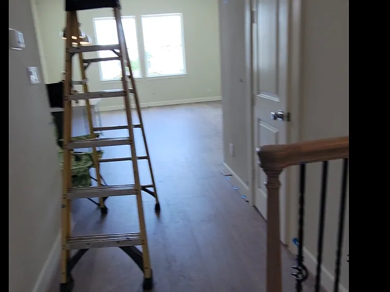 stairs lead to kitchen, dining, living room area
