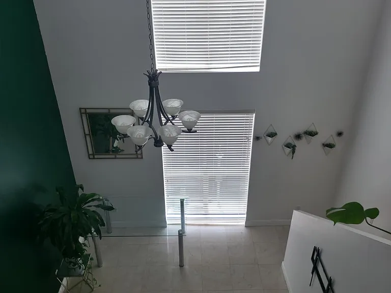 living room with 2 large windows and high ceiling concept. View from 2nd floor