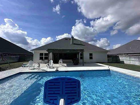 Salt water pool includes jets in the shallow lounging area.