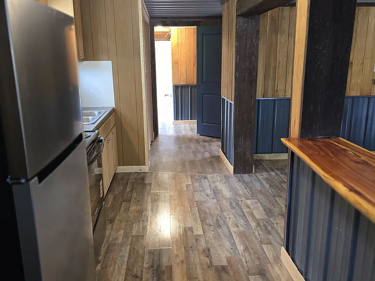 Kitchen with counter connected to living room