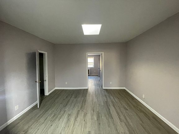 Living room with closet and skylight.