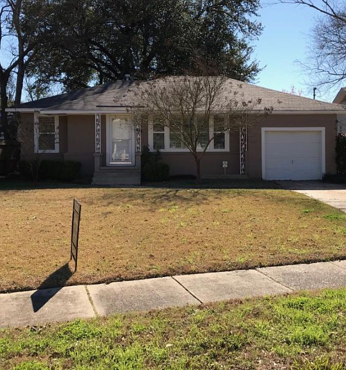 Front with garage door and plantation shutters
