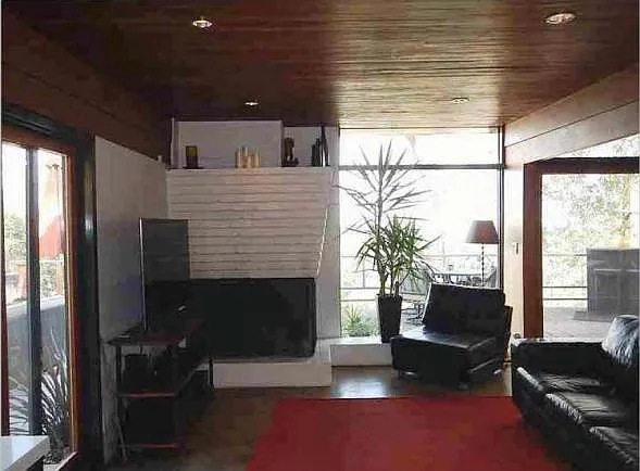 Bright, open living room with a striking wall of windows that fills the space with natural light.