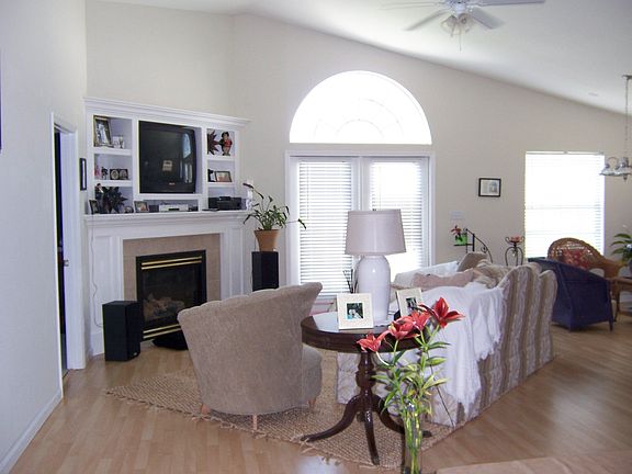 Spacious living room with wood floors, cathedral ceilings, and gas fireplace
