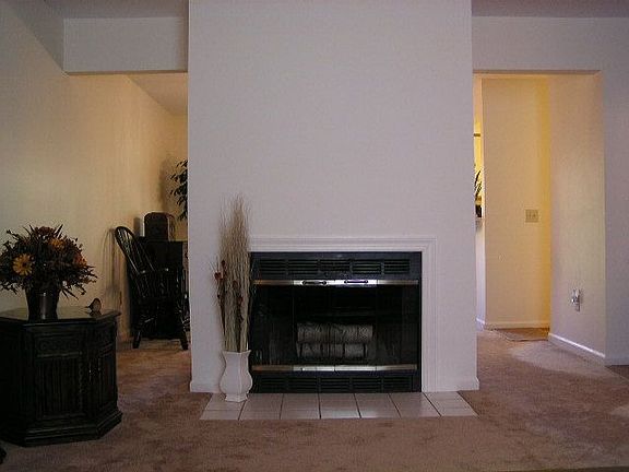 Fireplace Separates Living Room from Dining Room