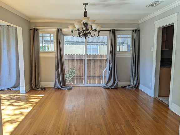Dining space leading off of living room and into the kitchen. Large sliders provide light and air throught out the the entire space. Dining room also leads onto the spacious sunroom overlooking the quiet front yard.
