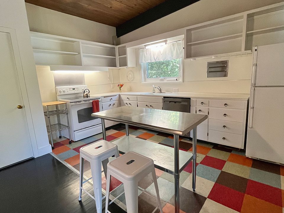 Stainless steel breakfast island, open cabinets and HE dishwasher.