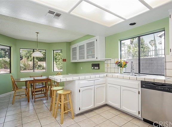 Kitchen looks out to breakfast nook and fabulous E
