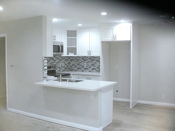 Chair-height bar and dining area at right for entertaining.