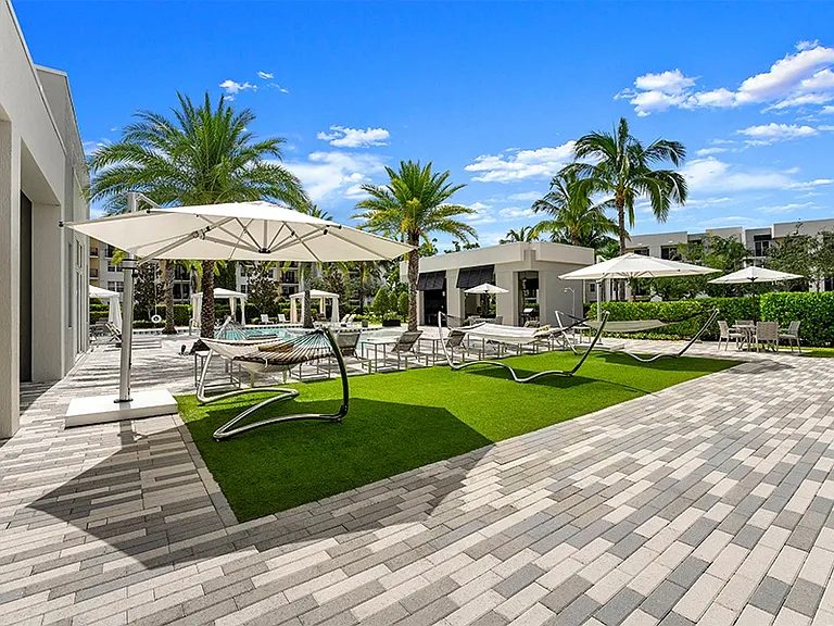 The expansive sundeck features hammocks and cabanas