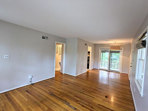 Open living/dining floor plan with modern pendant lighting. Gorgeous hardwood floors throughout home.