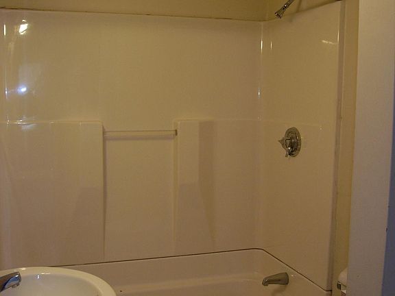 Modern bath with ceramic tile flooring.