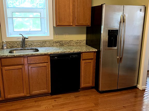 1st: sink looking out to woods, dishwasher, side-by-side refrigerator/ freezer
