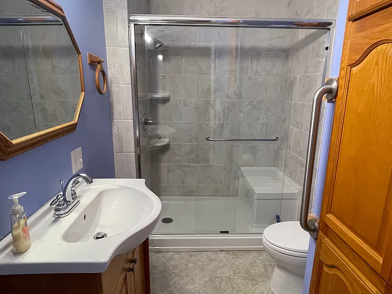 Updated bathroom with tile shower and acrylic insert with seat. Substantial built in storage.